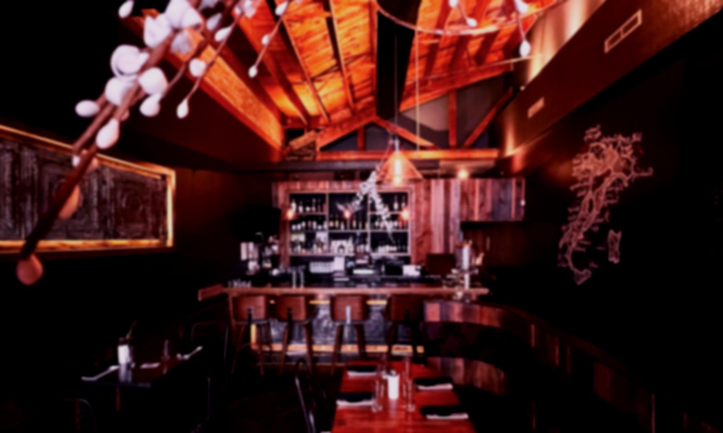 Dining room at Eduardo's Enoteca with wine bottles lining the walls