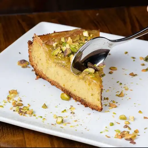 Pistachio cheesecake slice with caramel drizzle at Eduardo's Enoteca